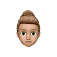 Memoji of a woman with brunette hair, worn as bun